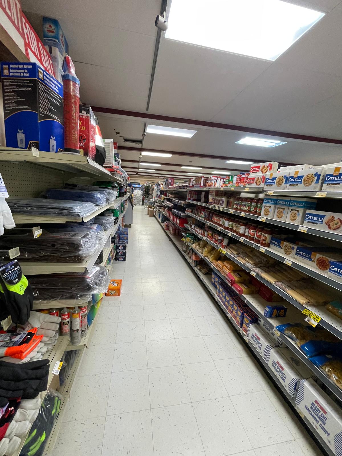 Well-stocked aisle inside KAN's General Store with household items and supplies